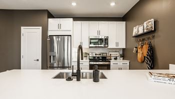 Modern kitchen with stainless steel appliances and double door refrigerators